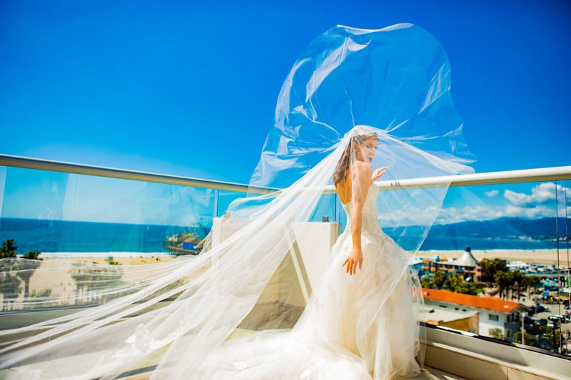 Happy Bride in Veil on Balcony
Photography: Laura Grier of Beautiful Day Photography
Read More:
http://www.insideweddings.com/weddings/romantic-timeless-garden-inspired-jewish-wedding-at-a-country-club/1292/ bride in monique lhuillier wedding dress and veil blowing in wind ocean view balcony