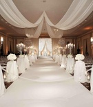 All-White Ceremony Décor
Photography: Bob %26 Dawn Davis Photography
Read More:
http://www.insideweddings.com/weddings/spring-wedding-in-chicago-with-purple-lighting/381/ Clear candelabra on pedestals and chandeliers