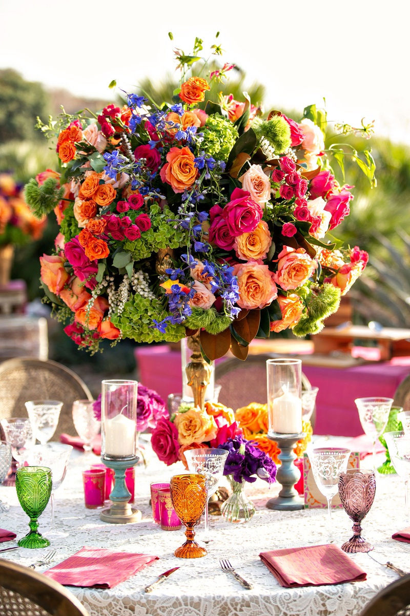 Vibrant Reception Centerpiece %26 Glasses
Photography: Laurie Bailey Photography
Read More:
http://www.insideweddings.com/weddings/outdoor-jewish-ceremony-reception-with-colorful-bohemian-decor/1330/ wedding reception lace linen cane chair green orange purple goblets orange pink green flowers