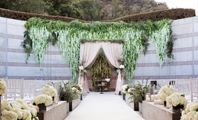 Greenery %26 Wisteria Ceremony Décor
Photography: Kevin Weinstein Photography
Read More:
http://www.insideweddings.com/weddings/high-school-sweethearts-say-i-do-at-personalized-jewish-wedding/977/ Skirball Cultural Center Jewish wedding ceremony outdoor greenery blush white flowers wisteria