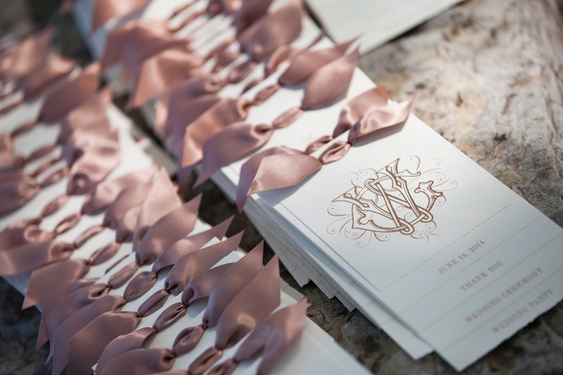 White Programs with Pink Bows at Top
Photography: Michael Bambino %26 Co.
Read More:
http://www.insideweddings.com/weddings/whimsical-open-air-secret-garden-wedding-with-soft-spring-hues/777/ delicate white programs with gold calligraphy and pink bows