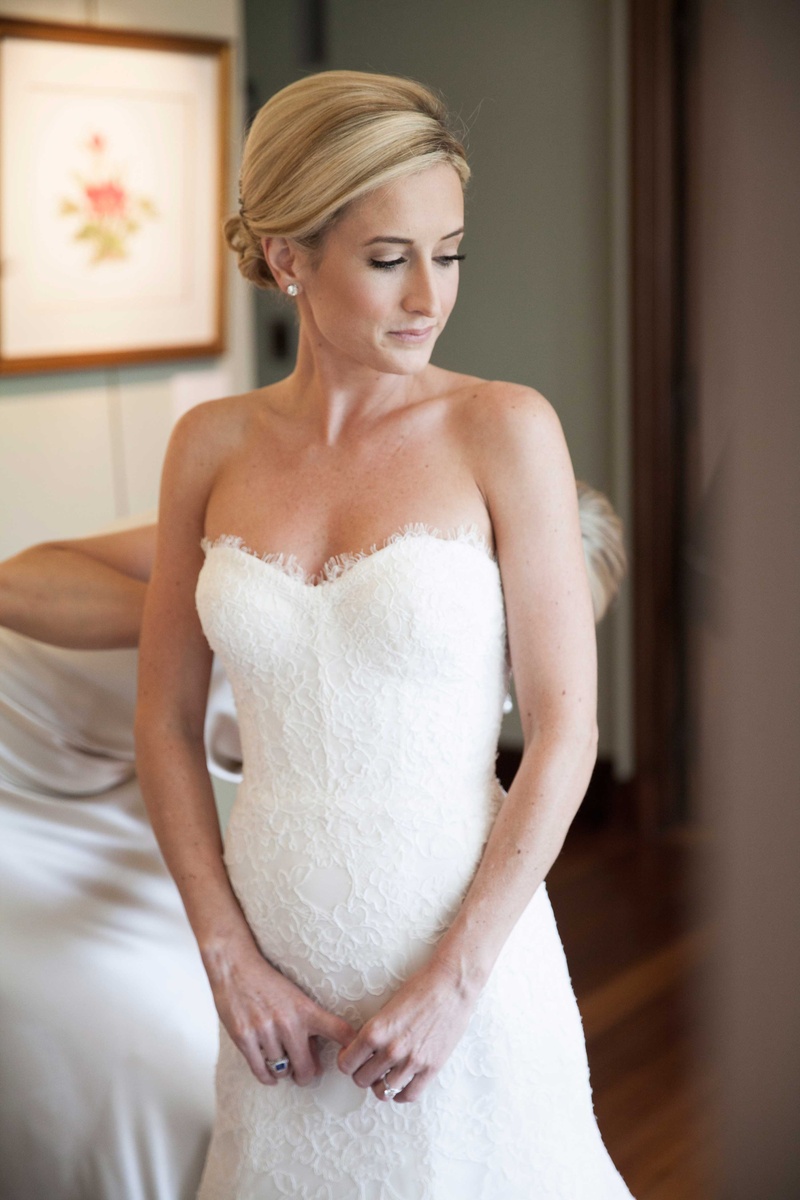 Bride Gets Zipped into Gown
Photography: Michael Bambino %26 Co.
Read More:
http://www.insideweddings.com/weddings/whimsical-open-air-secret-garden-wedding-with-soft-spring-hues/777/ an excited bride gets zipped into her lace Monique Lhuillier wedding gown by one of her bridesmaids