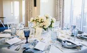 Blue Napkins %26 Goblets
Photography: Palos Studio
Read More:
http://www.insideweddings.com/weddings/ocean-view-ceremony-classic-reception-with-soft-blue-color-scheme/1371/ wedding reception ballroom round table low centerpiece ivory flowers blue glassware velvet napkin
