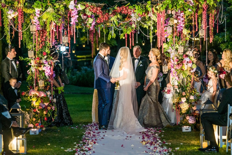 Bride %26 Groom Under Whimsical Chuppah
Photography: Robert Evans for 5th Avenue Digital
Read More:
http://www.insideweddings.com/weddings/outdoor-jewish-wedding-ceremony-at-stunning-chateau-in-new-jersey/1058/ Bride in anne barge wedding dress with groom in navy suit under greenery chuppah with flowers