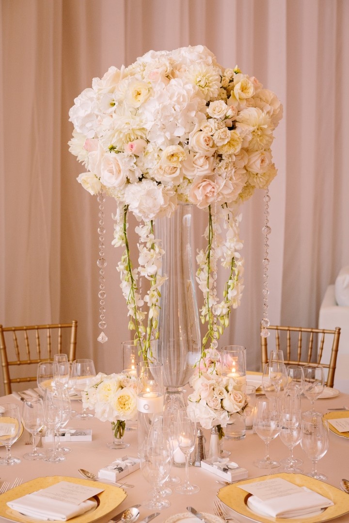 Cascading Orchids and Crystals
Photography: Brian Leahy Photography
Read More:
http://www.insideweddings.com/weddings/a-classic-romantic-celebration-with-lush-florals-in-beverly-hills/973/ tall, flurry centerpiece of ivory blossoms with cascading crystals and orchids