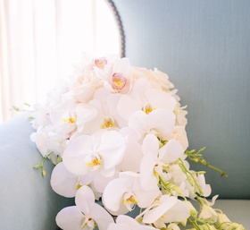 Cascading Bouquet with Orchids and Roses
Photography: Brian Leahy Photography
Read More:
http://www.insideweddings.com/weddings/beachy-southern-california-ceremony-winter-wonderland-reception/877/ white orchids and ivory roses with cascading greenery on blue love seat