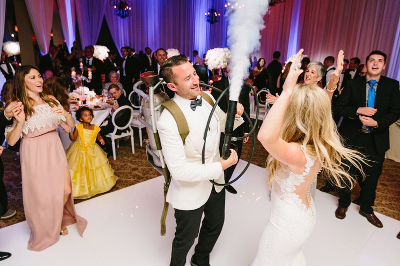 Groom with Carbon Dioxide Tank
Photography: Jodee Debes Photography
Read More:
http://www.insideweddings.com/weddings/elegant-alfresco-ceremony-reception-with-parisian-elements/1176/ groom with carbon dioxide tank at wedding reception to fill dance floor with fog