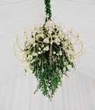 Verdant Chandelier
Photography: Brandon Chesbro
Read More:
http://www.insideweddings.com/weddings/classic-white-wedding-at-a-historic-estate-in-nashville/1219/ crystal chandelier accented with greenery and ivory roses at tented wedding reception