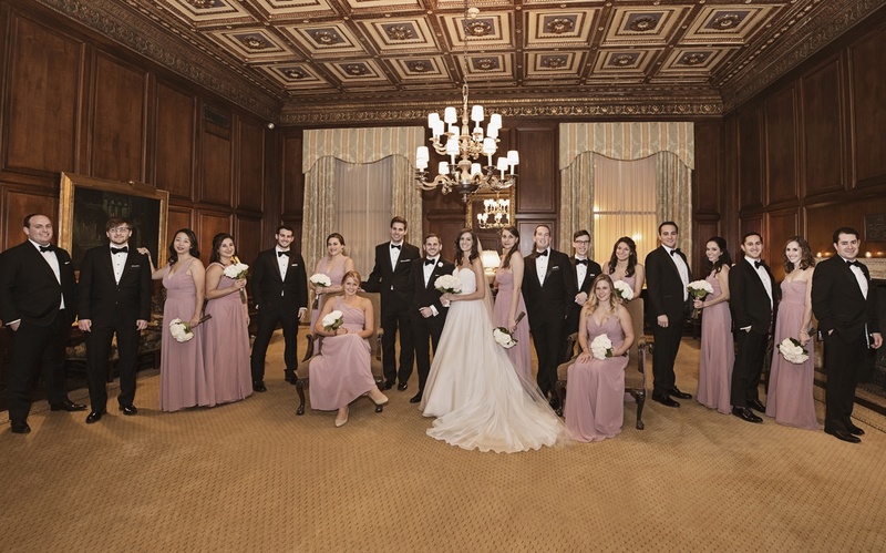 Large Wedding Party in Formal Room
Photography: Carasco Photography
Read More:
http://www.insideweddings.com/weddings/jewish-wedding-with-classic-ivory-and-gold-decor-in-chicago/983/ bride in essence of australia wedding dress, groom in bonobos tux, bridesmaids in monique lhuillier