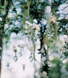 Suspended Vases and Candles
Photography: MBV Photography
Read More:
http://www.insideweddings.com/weddings/asian-inspired-summer-wedding-in-the-hills-of-north-carolina/159/ Cone-shaped vessels hanging from tree