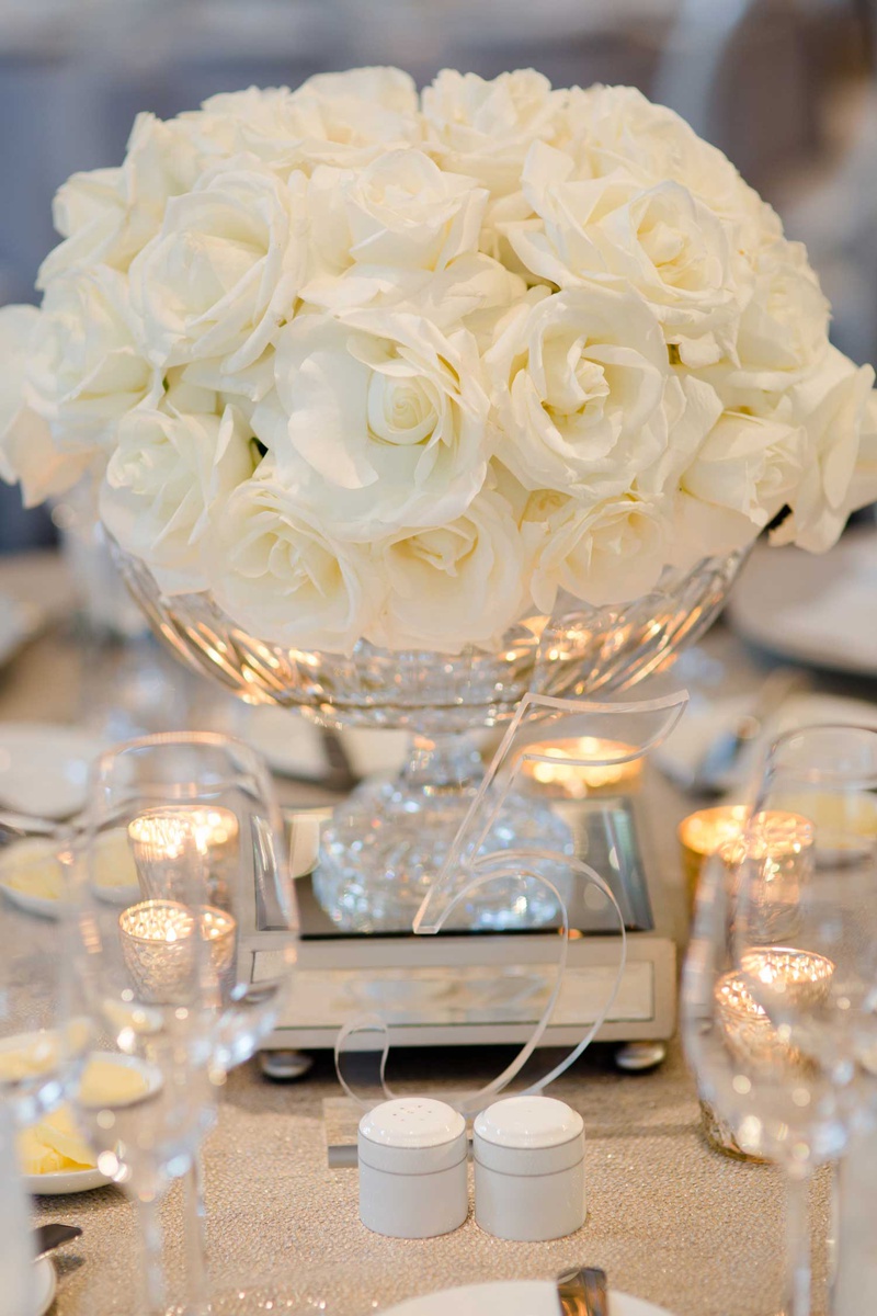 Acrylic Table Number with Roses
Photography: Studio This Is
Read More:
http://www.insideweddings.com/weddings/glamorous-city-style-real-wedding-at-a-luxury-hotel-in-chicago/1217/ wedding reception centerpiece low arrangement white roses clear number five lucite