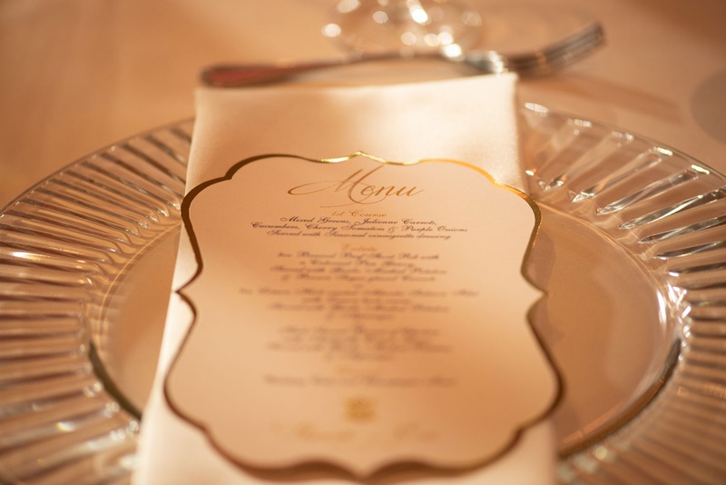 Die-Cut Menu with Gold Foil
Photography: Kesha Lambert Photography
Read More:
http://www.insideweddings.com/weddings/elegant-white-gold-country-club-wedding-in-north-carolina/1282/ wedding reception clear glass charger plate white napkin white gold menu card die cut gold border