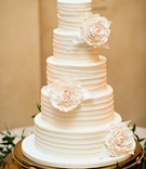 White Wedding Cake with Sugar Flowers
Photography: Kristen Weaver Photography
Read More:
http://www.insideweddings.com/weddings/a-tuscan-themed-jewish-wedding-in-florida-with-natural-details/654/ White wedding cake with textured frosting and white sugar peonies