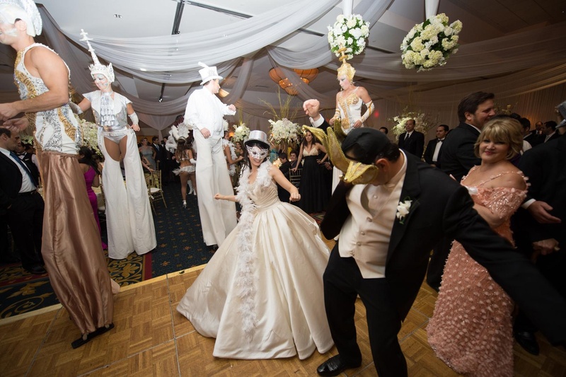 Masquerade Dance Party
Photography: Justin Marantz
Read More:
http://www.insideweddings.com/weddings/unforgettable-miami-wedding-with-acrobats-tiger-cubs-fireworks/437/ Bride and groom in Venice style masks with stilt performers