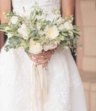 Neutral Bouquet with Ribbons
Photography: Triple Cord Photography
Read More:
http://www.insideweddings.com/weddings/destination-wedding-with-outdoor-reception-lavish-after-party/982/ Neutral bouquet with greenery and garden roses, ranunculus blossoms with dangling ribbon