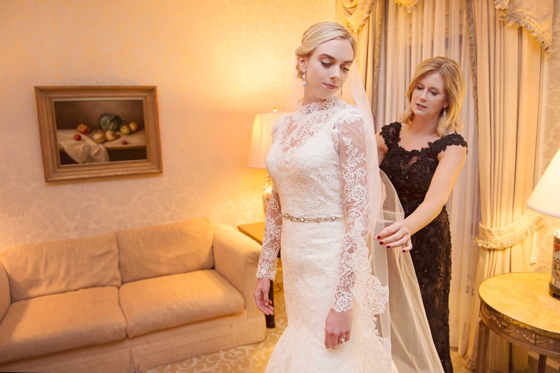Bride Getting Ready with Mother of the Bride
Photography: Carasco Photography
Read More:
http://www.insideweddings.com/weddings/new-york-yankees-infielder-marries-in-opulent-chicago-soiree/764/ Bride in wedding dress with lace over top gets ready with her mom on wedding day
