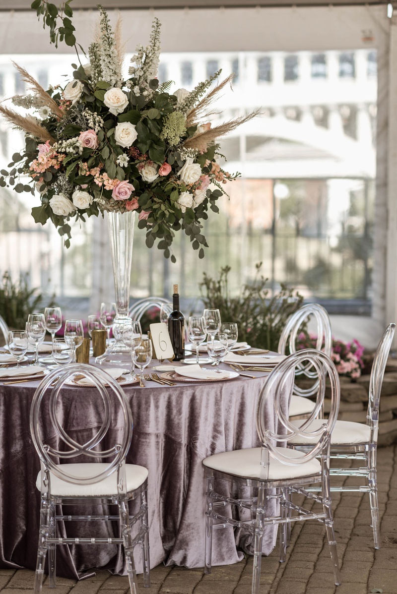 Lavender Table Linens %26 Tall Arrangement
Photography: Belle Ombre Photography
Read More:
http://www.insideweddings.com/weddings/vintage-bohemian-inspired-wedding-on-historic-bridge-in-cleveland/1373/ boho chic wedding reception clear tent velvet purple linen acrylic oval chair tall centerpiece