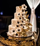 Coconut Cake with Anemone Flowers
Photography: Laurie Bailey Photography
Read More:
http://www.insideweddings.com/weddings/classic-elegant-country-club-wedding-in-los-angeles-california/1149/ Four layer wedding cake with coconut shavings sugar anemone flowers gold leaves