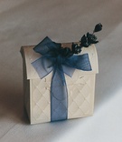 White Favor Box with Blue Ribbon
Photography: Shannon’s Photography
Read More:
http://www.insideweddings.com/weddings/summer-wedding-with-garden-inspired-decor-in-california/50/ Ivory favor boxes tied with sheer ribbon and sprig