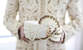 Groom's Turban
Photography: Mel Barlow %26 Co.
Read More:
http://www.insideweddings.com/weddings/reshma-shetty-and-deep-katdare/377/ Groom's white turban decorated with red and gold stones for an Indian Hindu Wedding