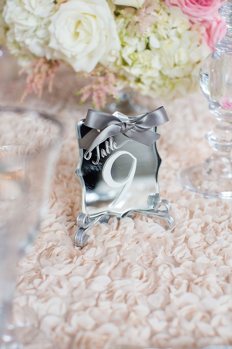 Mirror Table Number with White Calligraphy
Photography: Sarah Kate, Photographer
Read More:
http://www.insideweddings.com/weddings/outdoor-fall-ceremony-opulent-tented-reception-in-dallas-texas/1022/ Mirror table number die cut white calligraphy and grey ribbon textured linens