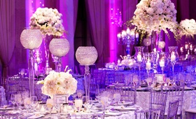 Crystal Reception Décor
Photography: Bob %26 Dawn Davis Photography
Read More:
http://www.insideweddings.com/weddings/spring-wedding-in-chicago-with-purple-lighting/381/ Clear Lucite chairs and white rosette linens