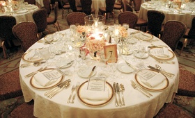 Round Guest Tables
Photography: Thomas J. Styczynski Photography
Read More:
http://www.insideweddings.com/weddings/classic-ballroom-wedding-in-santa-barbara-california/107/ Large vase with candles, gold plates and flatware