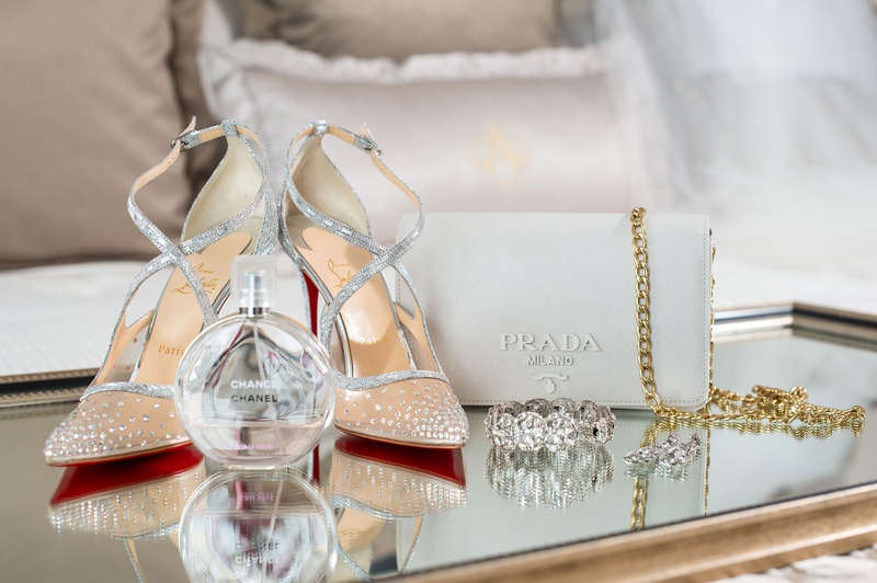 Designer Heels, Perfume %26 Bridal Purse
Photography: Suzanne Delawar Studios
Read More:
http://www.insideweddings.com/weddings/intimate-oceanfront-wedding-with-romantic-red-pink-white-palette/1235/ wedding accessories christian louboutin red bottom heels mesh jewels chanel perfume prada clutch
