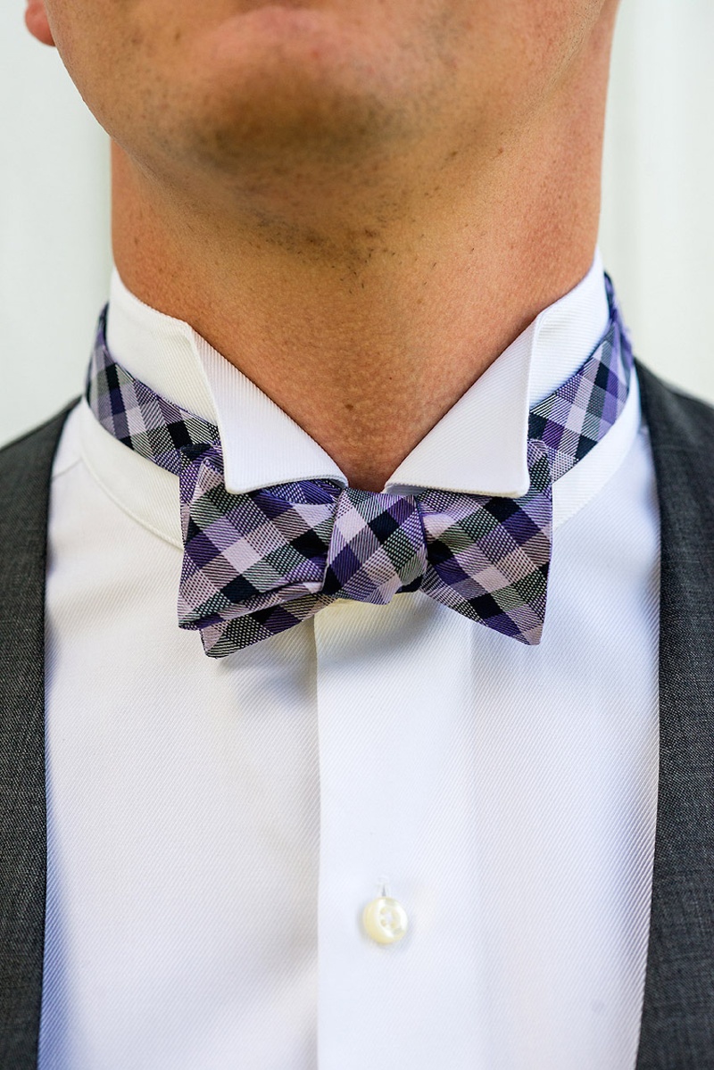 Purple Bow Tie
Photography: Stacy Newgent
Read More:
http://www.insideweddings.com/weddings/rustic-barn-wedding-tented-reception-on-family-farm-in-ohio/690/ Groom groomsmen attire with grey vest and purple plaid bow tie