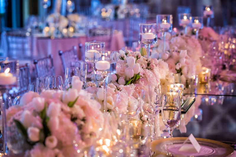 Low Rose %26 Tulip Centerpiece
Photography: Muñoz Photography
Read More:
http://www.insideweddings.com/weddings/colorful-jewish-ceremony-ballroom-reception-at-the-breakers/818/ Wedding reception table with violet lighting, mirror top, white tulip, white pink rose, candles