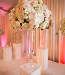 Tall Arrangements at Ceremony
Photography: Anna and Spencer Photography
Read More:
http://www.insideweddings.com/weddings/elegant-interfaith-wedding-with-a-secret-garden-theme-in-atlanta/1178/ indoor ceremony, floral arrangements with orchids, hydrangeas, roses in crystal vase on white pillar