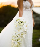 Cascading Bouquet of White Orchids, Other Blooms
Photography: Joe Laurin Photography
Read More:
http://www.insideweddings.com/weddings/simple-chic-seaside-wedding-with-white-palette-in-rhode-island/953/ cascading bouquet white orchids other blooms roses greenery extended unique sophisticated