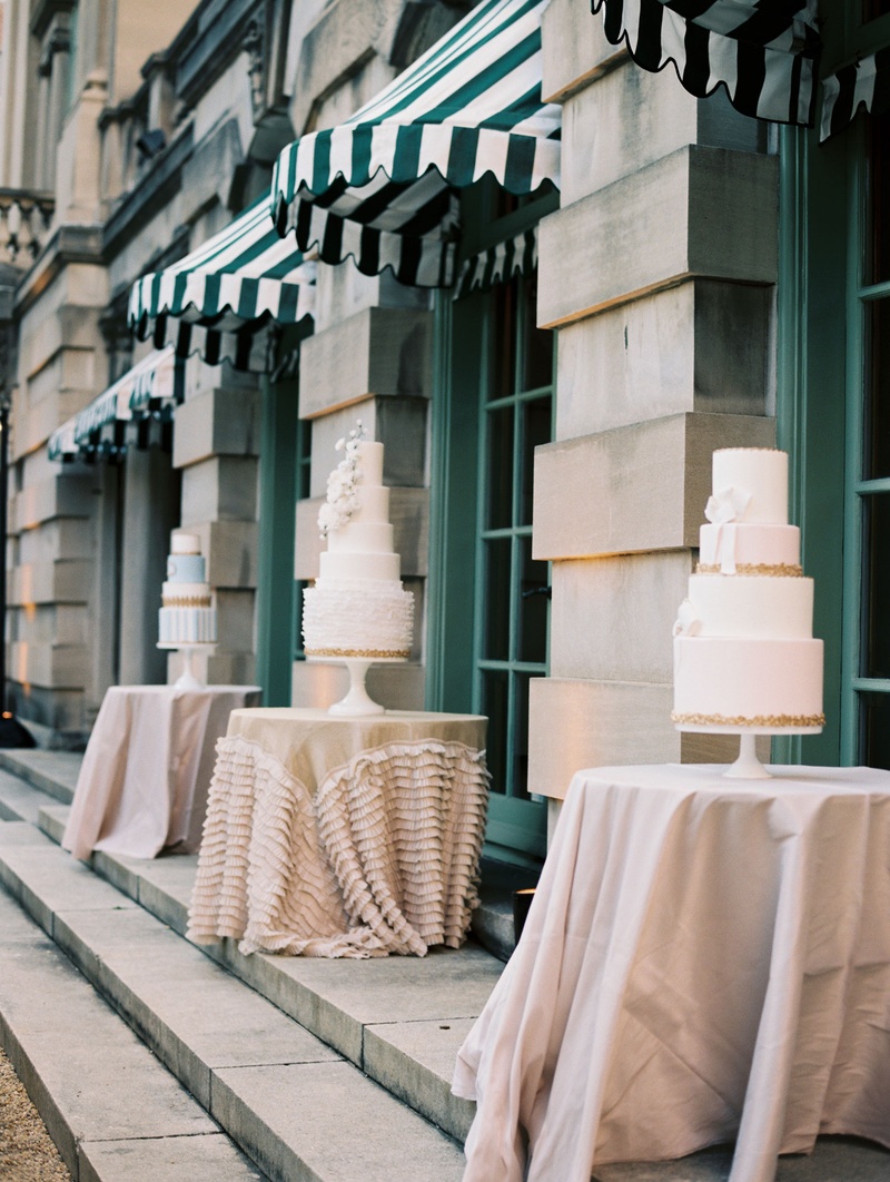 Three Cakes on Separate Displays
Photography: Abby Jiu Photography
Read More:
http://www.insideweddings.com/weddings/chic-parisian-romance-inspired-spring-wedding-in-washington-dc/1038/ Wedding cakes displayed on small tables with linens at wedding reception outdoors by pool DC