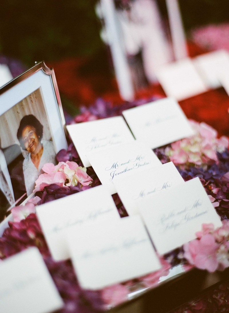 Simple Escort Cards Next to Family Photos
Photography: Mi Belle Photographers
Read More:
http://www.insideweddings.com/weddings/colorful-outdoor-wedding-with-supper-club-theme-in-los-angeles-ca/741/ Wedding escort cards with calligraphy on top of pink and purple flowers next to old family photos