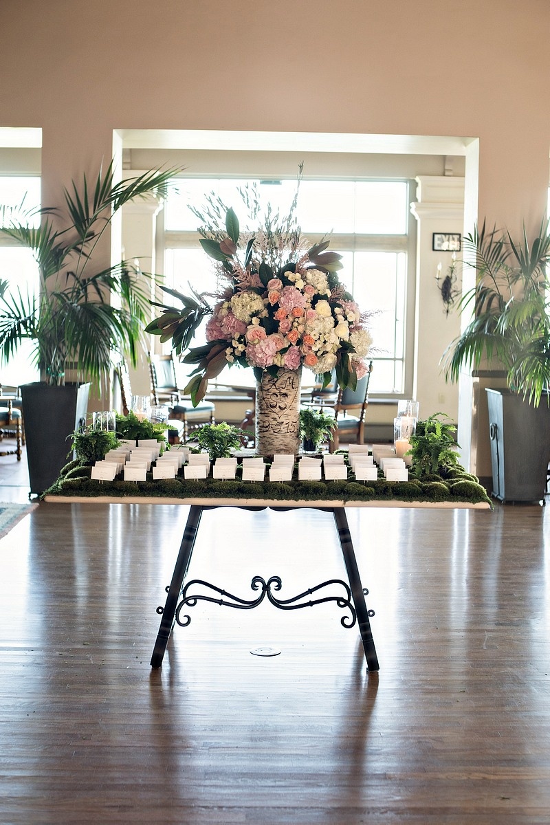 Escort Cards on a Bed of Moss
Photography: Laurie Bailey Photography
Read More:
http://www.insideweddings.com/weddings/oceanfront-wedding-ceremony-classic-romantic-ballroom-reception/854/ wedding escort cards on table covered in moss, flower arrangement in birch tree trunk