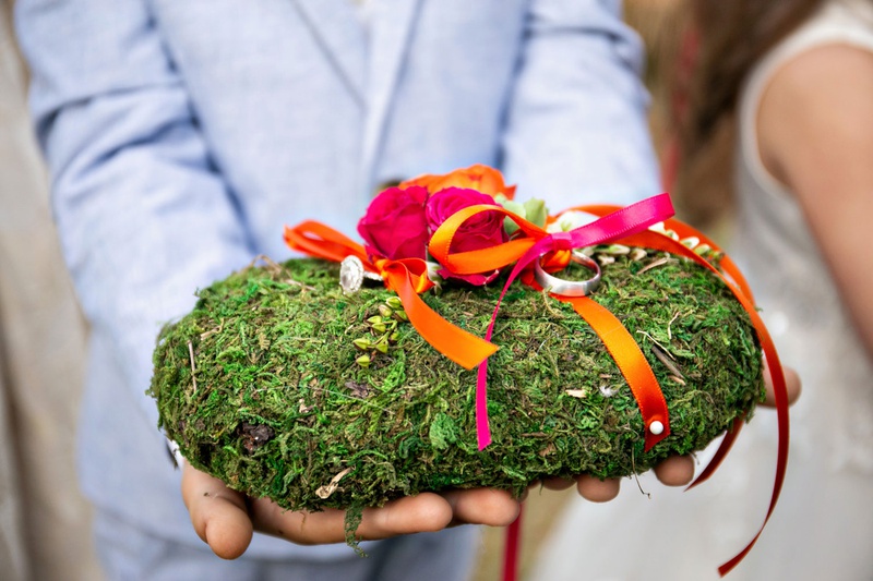 Ring Bearer Moss "Pillow"
Photography: Laurie Bailey Photography
Read More:
http://www.insideweddings.com/weddings/outdoor-jewish-ceremony-reception-with-colorful-bohemian-decor/1330/ ring bearer pillow covered with moss hot pink and orange rose flowers and ribbons