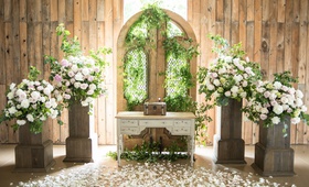 Romantic Altar in a Barn
Photography: Little Tree Studios
Read More:
http://www.insideweddings.com/weddings/brian-winters-of-the-new-york-jets-romantic-rustic-chic-wedding/1245/ rustic-chic barn wedding ceremony, floral arrangements on wooden stand, gate with greenery