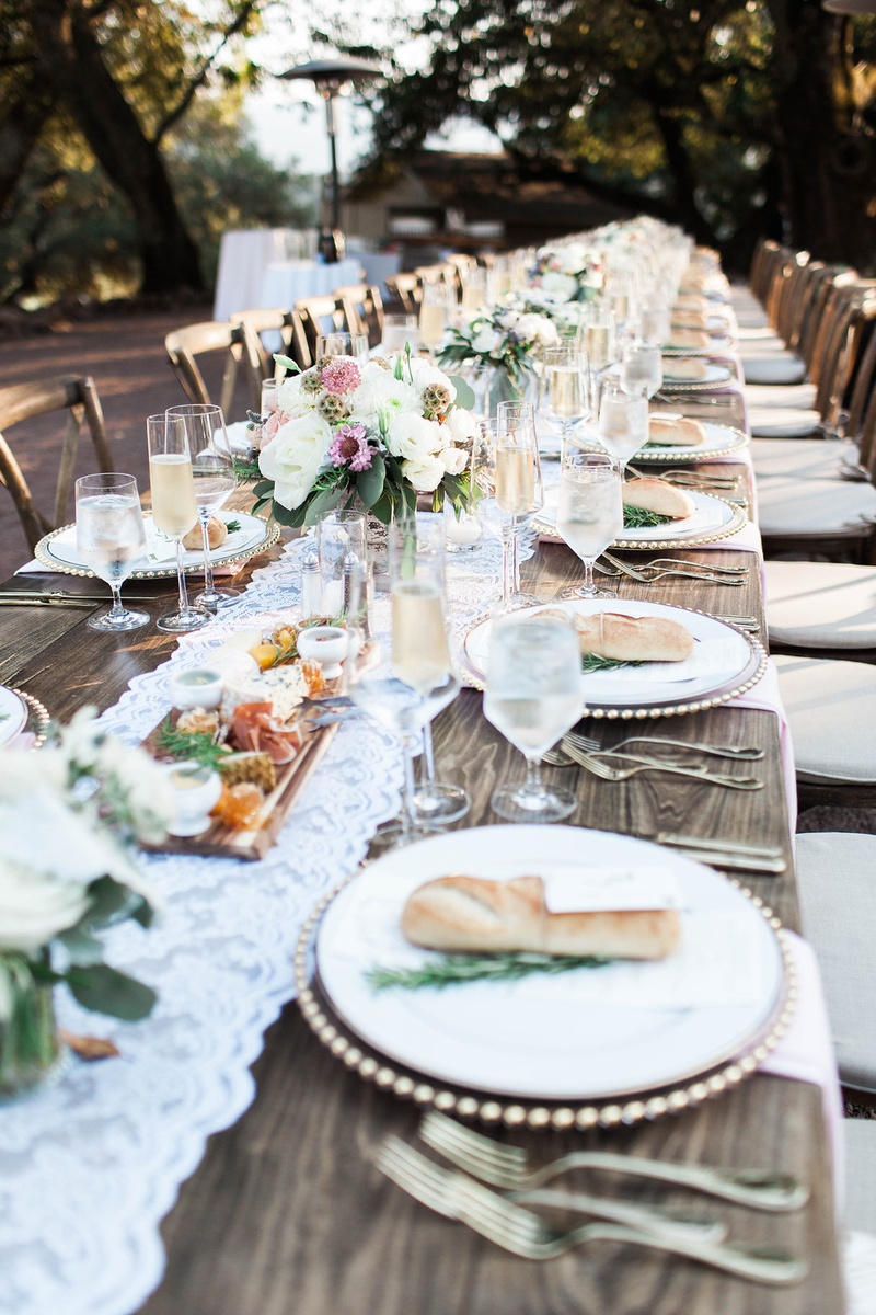 Extended Wooden Tables, Lace Runner, Florals
Photography: Katie Shuler Photography
Read More:
http://www.insideweddings.com/weddings/rustic-chic-outdoor-wedding-at-a-winery-in-northern-california/945/ extended wooden tables lace runner florals simple rustic chic wedding reception winery bread