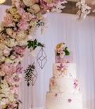 Hand-Painted Lavender Wedding Cake
Photography: Amy Anaiz Photography
Read More:
http://www.insideweddings.com/weddings/luxe-springtime-wedding-inspiration-shoot-with-delectable-desserts/1120/ Wedding cake with lavender top tier, ruffle bottom layer, and middle layers of floral hand-painted