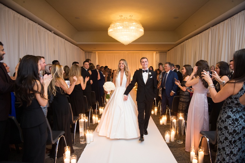 Newlyweds Smiling During Recessional
Photography: Abby Jiu Photography
Read More:
http://www.insideweddings.com/weddings/modern-wedding-with-a-black-and-white-palette-in-washington-dc/1236/ bride in romona keveza a-line gown plunging neckline with groom recessional