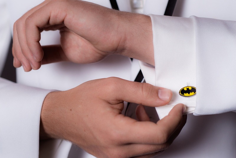 Batman Logo Cuff Link
Photography: Gold Grid Studios
Read More:
http://www.insideweddings.com/weddings/celebratory-wedding-shoot-with-elegant-romantic-decor-in-chicago/728/ Wedding guest in white tuxedo jacket wears batman logo cuff link with white shirt