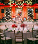 Festive Holiday-Themed Wedding Reception
Photography: Harwell Photography
Read More:
http://www.insideweddings.com/weddings/magical-winter-wedding-with-luxurious-red-white-holiday-decor/1208/ white linen gold chairs red flowers tall floating candles gold ornaments green garland dance floor