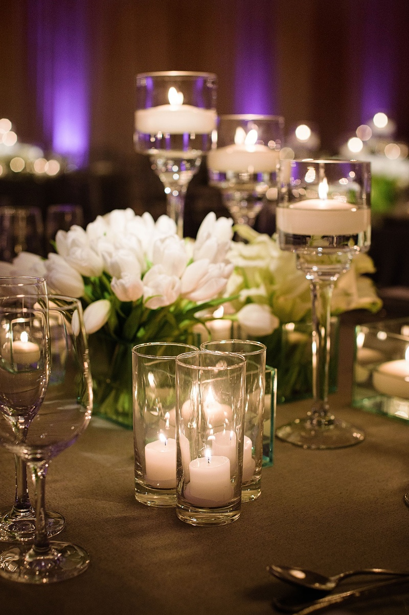 Tulips on Table with Grey Linens
Photography: Next Exit Photography
Read More:
http://www.insideweddings.com/weddings/alfresco-interfaith-ceremony-ballroom-reception-in-santa-monica/963/ Wedding reception purple lighting floating candles candle votives white tulips in clear glass vase
