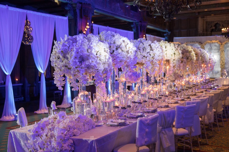 Long Table with Blue-Violet Lighting
Photography: Collin Pierson Photography
Read More:
http://www.insideweddings.com/weddings/winter-wedding-inspirational-shoot-with-opulent-frosted-decor/1108/ Wedding reception drapery long table with runner and tall centerpieces white orchid flowers