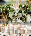 White Rose %26 Hydrangeas on Gold Riser
Photography: Bob %26 Dawn Davis Photography
Read More:
http://www.insideweddings.com/weddings/classic-wedding-with-gold-details-greenery-at-library-in-chicago/1339/ wedding reception centerpiece gold riser white hydrangea rose greenery pillar candles tea lights