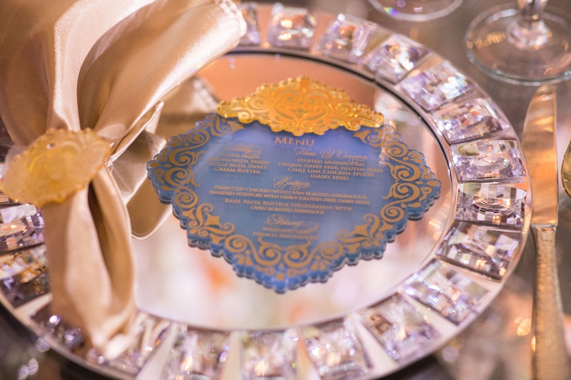 Blue-and-Gold Menu Design
Photography: Brian Bossany Photography
Read More:
http://www.insideweddings.com/weddings/luxurious-heaven-inspired-royal-wedding-celebration-in-minneapolis/1333/ royal wedding celebration african ghana royalty blue acrylic menu gold details matching napkin ring