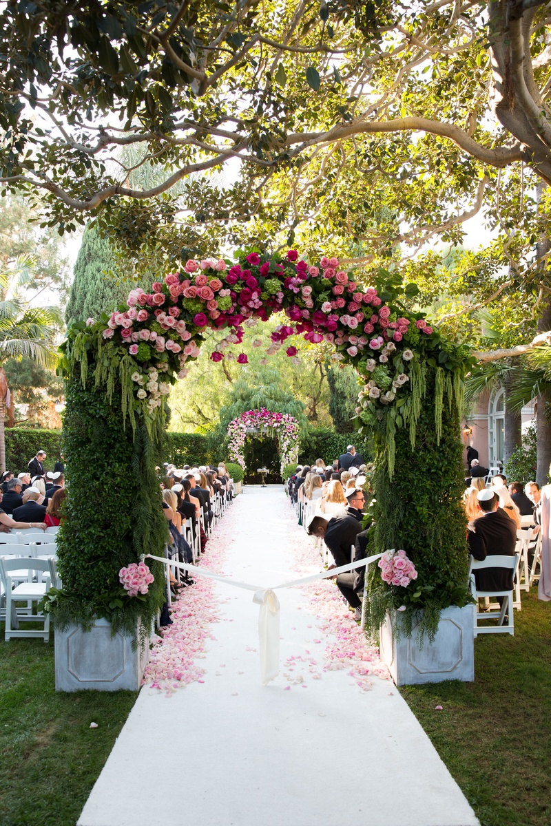 Archway of Greenery %26 Pink Blooms
Photography: Jay Lawrence Goldman Photography
Read More:
http://www.insideweddings.com/weddings/outdoor-ceremony-ballroom-reception-with-pink-flowers-greenery/1135/ Wedding ceremony outdoor wedding beverly hills hotel white aisle runner flower petals arch