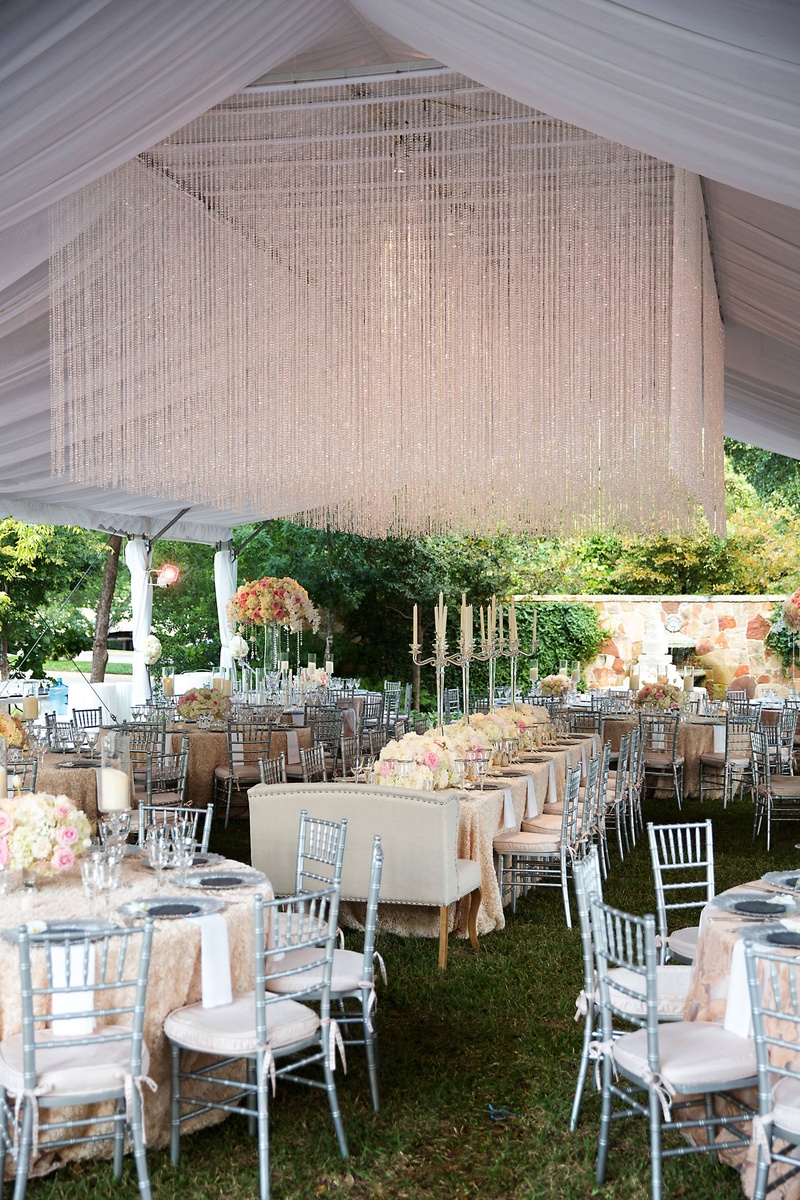 Tented Reception with Crystal Installation
Photography: Sarah Kate, Photographer
Read More:
http://www.insideweddings.com/weddings/outdoor-fall-ceremony-opulent-tented-reception-in-dallas-texas/1022/ Wedding reception green grass tent crystal installation flowers silver chairs settees candelabra