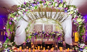 Sweetheart Table with Floral Arch
Photography: Wilson Sarkis Photography %26 Cinematography
Read More:
http://www.insideweddings.com/weddings/classic-church-ceremony-ballroom-reception-with-chic-purple-decor/1072/ Wedding reception sweetheart table tufted chairs arch of flowers candles reception ideas purple