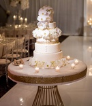 Orchids on White %26 Gold Wedding Cake
Photography: Lilly Photography
Read More:
http://www.insideweddings.com/weddings/traditional-greek-orthodox-ceremony-ballroom-reception-in-chicago/1105/ Wedding cake white and gold layers orchid flowers on top tiers candles on table